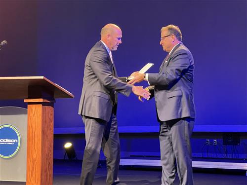 Mayor Paul Finley with Superintendent Dr. Ed Nichols on stage shaking hands