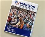 magazine cover of Madison City Schools showing audience of cheering students on cover