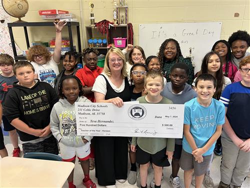 Horizon Teacher of the Year Tesa Hernandez surrounded by students