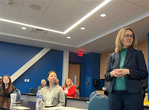 Dr. Natalia Dooley standing before audience explaining Madison City's EL situation