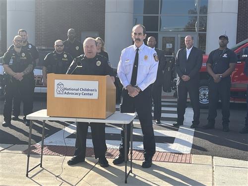 Police Chief Gandy and Fire Chief Bailey at podium in front of Journey Middle