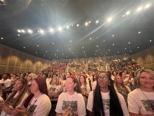  Wide angle photo of teachers packed in auditorium