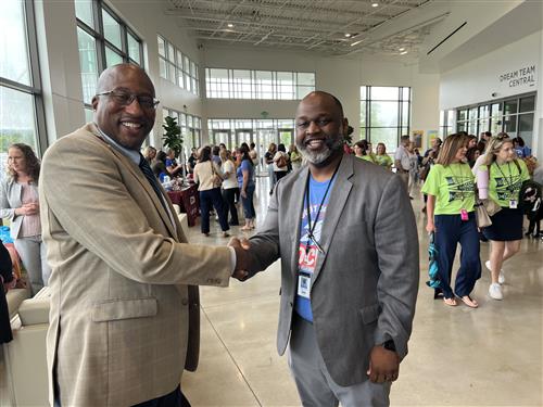 Board member travis cummings and Rainbow principal Quinten Turner