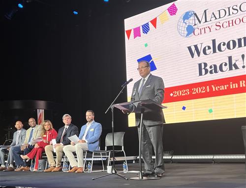 Superintendent Ed Nichols on stage with board members