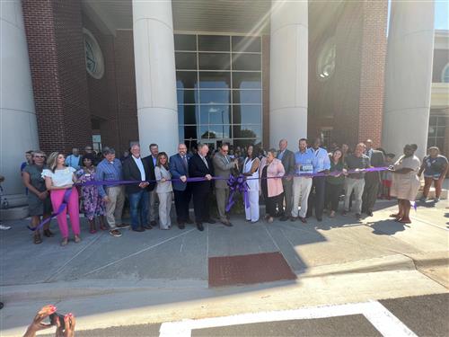 ribbon cutting in front of school