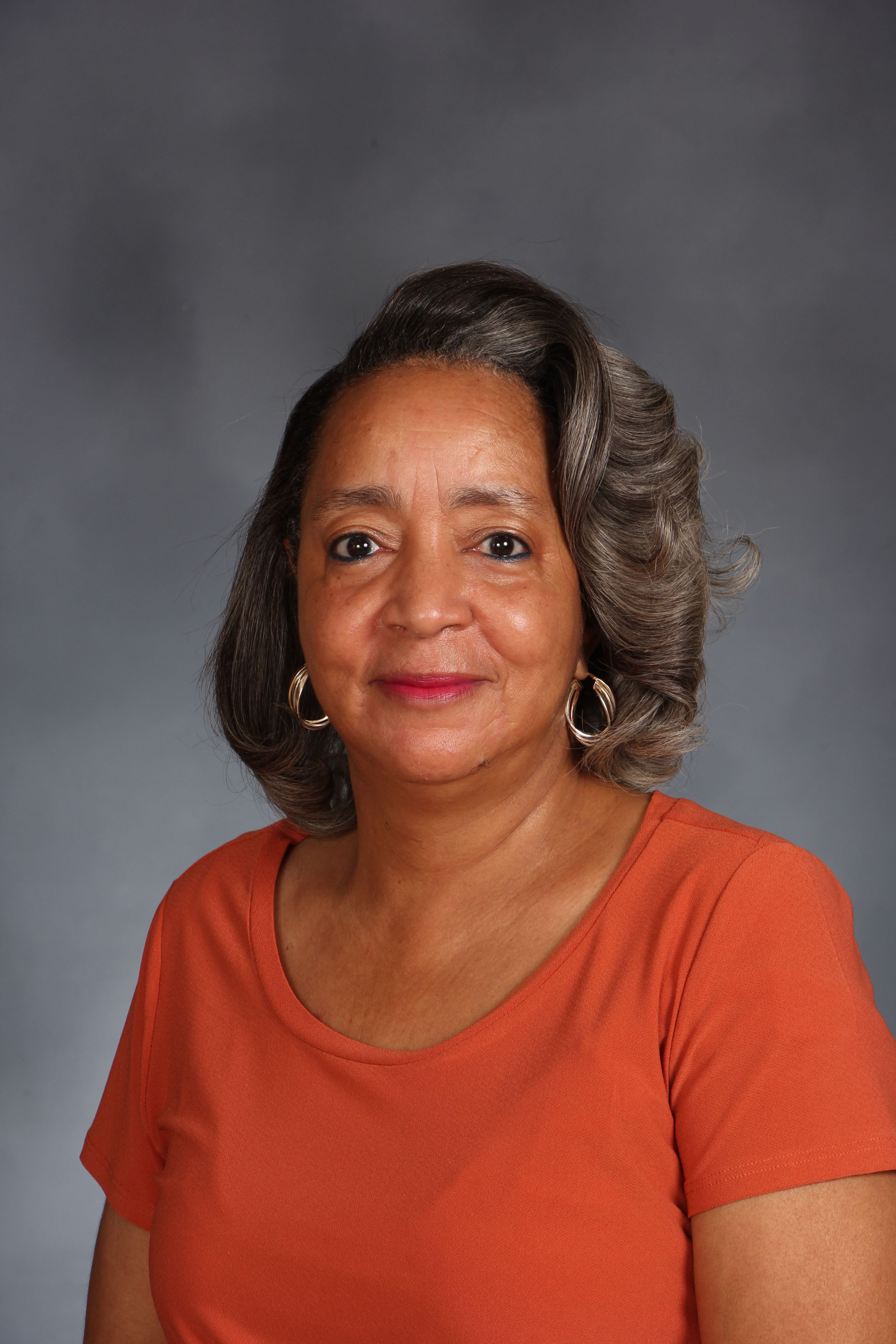 A headshot of a person with a happy expression.