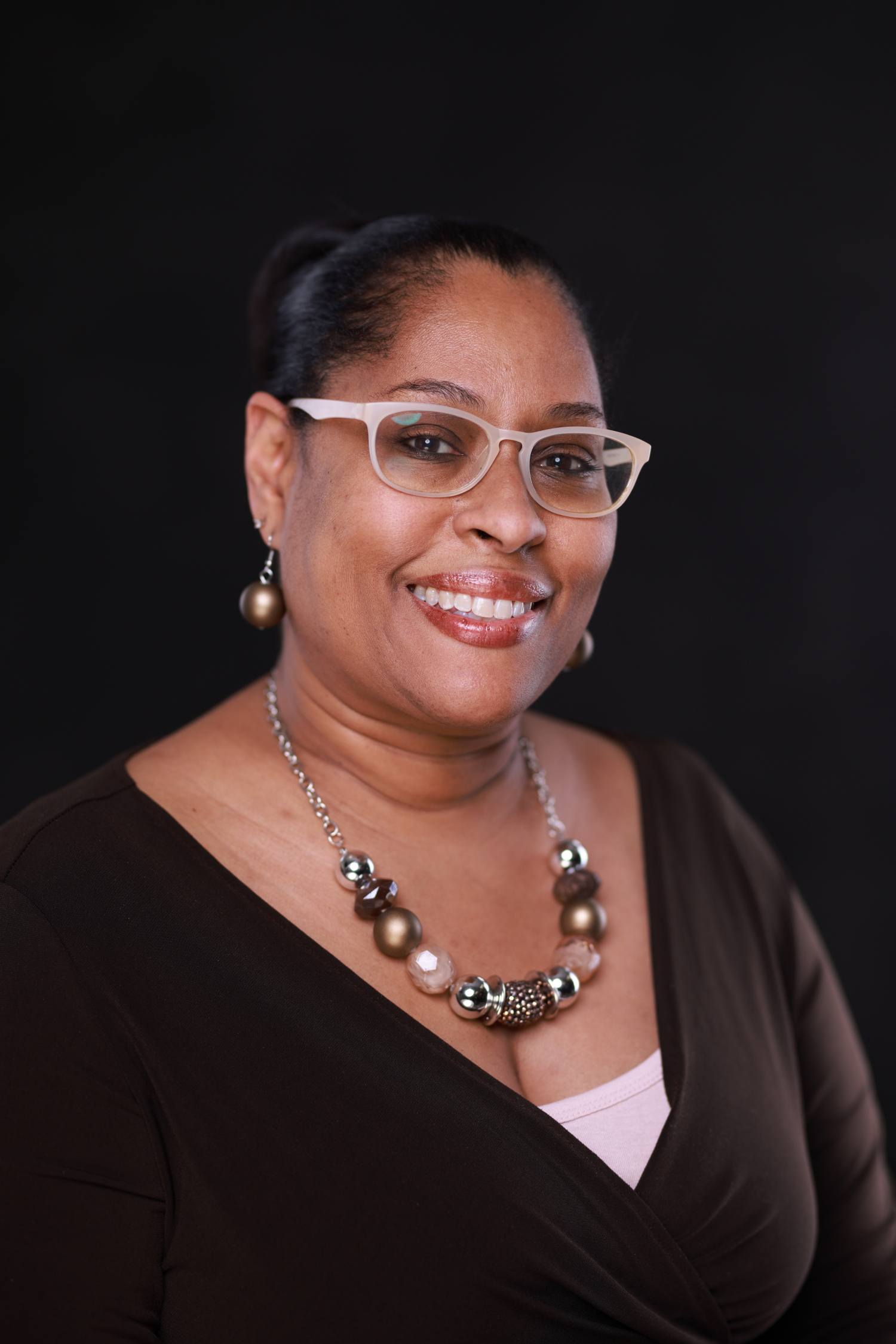 A headshot of a person smiling and looking at the camera.