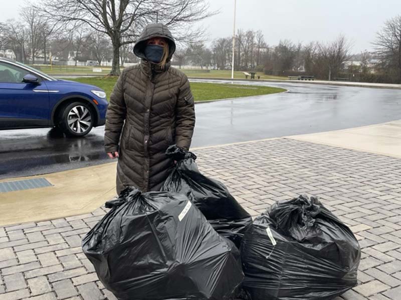 Student with bags full of toys
