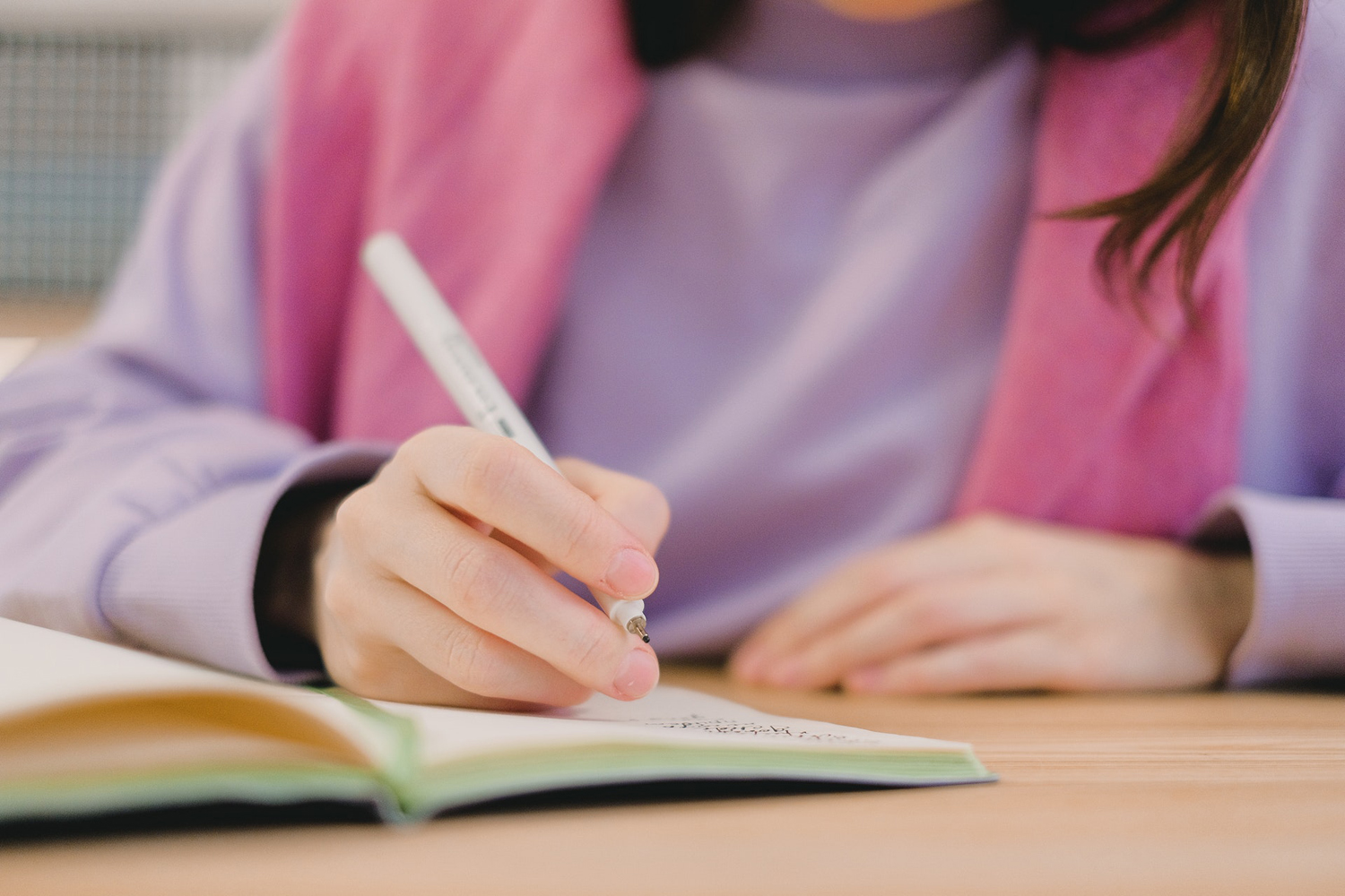 student writing in notebook