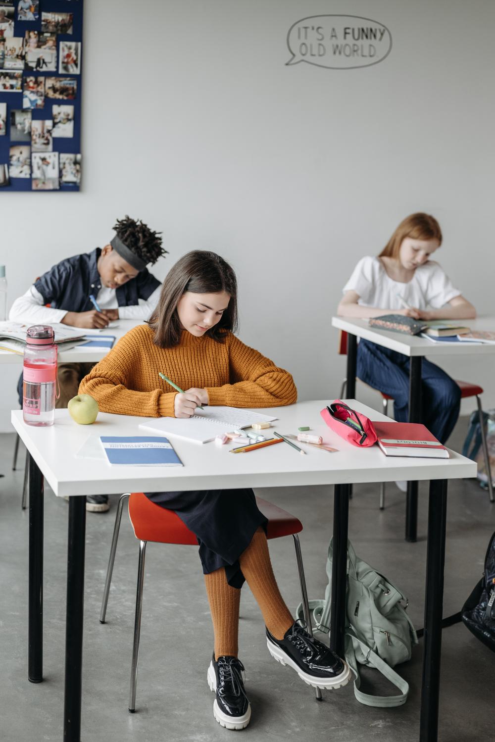 Students are working on their assignments in a classroom.