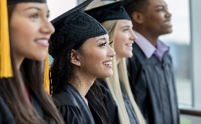 People standing in a row wearing graduation caps with tassels and gowns