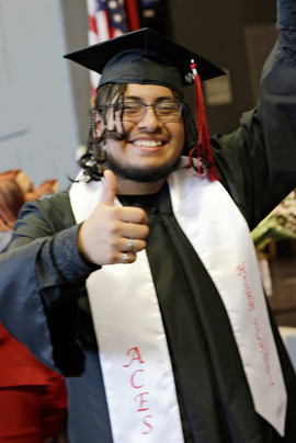 Aces graduate giving thumbs up