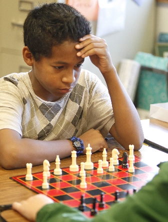 Student playing chess. 