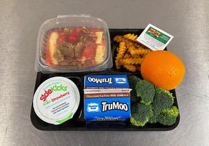 A lunch tray with yogurt parfait, fries, orange, broccoli, juice and milk