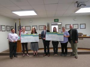 Idaho Power Reps present incentive checks to the Board.