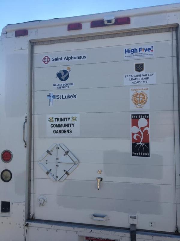 Logos for Traveling Table sponsors, shown on the back of the delivery truck.