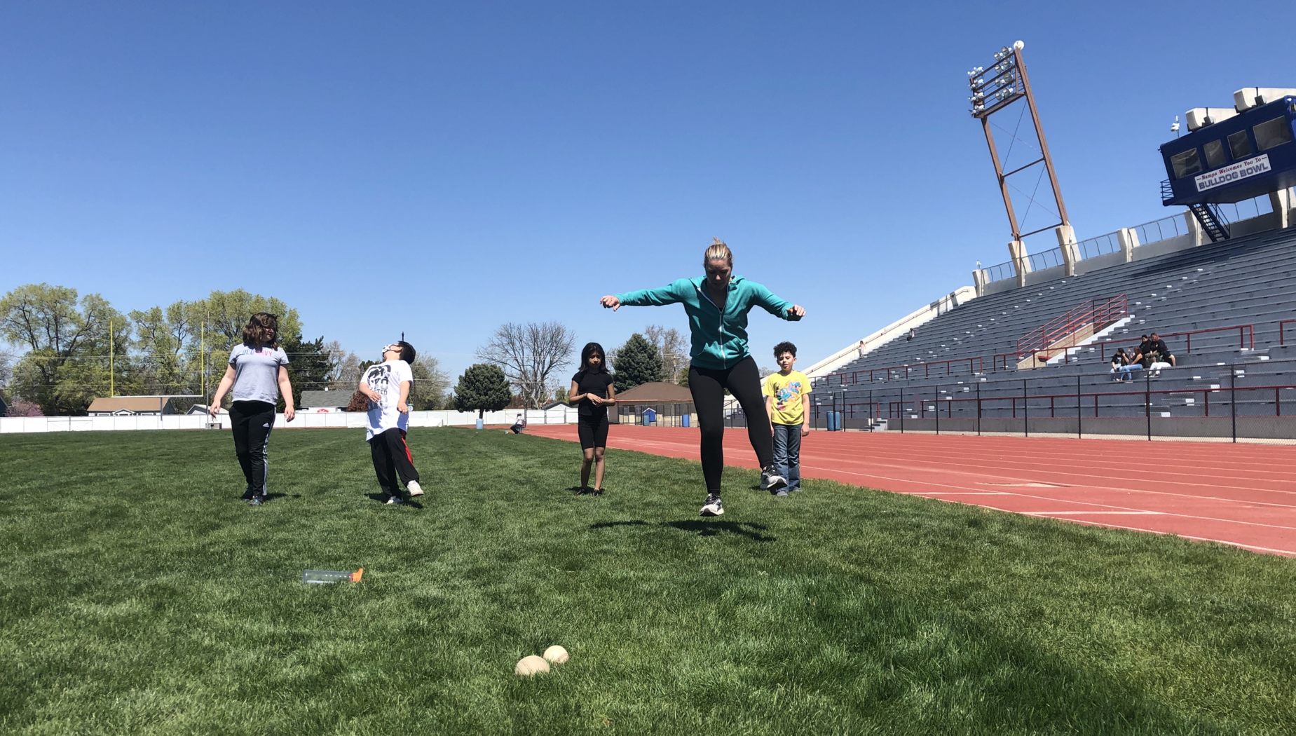 Coach Higgins practicing for the track meet with fifth-grade students.
