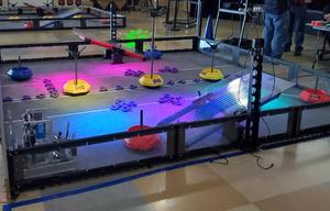 The robotics ring is set up with brightly colored lights on the various obstacles.