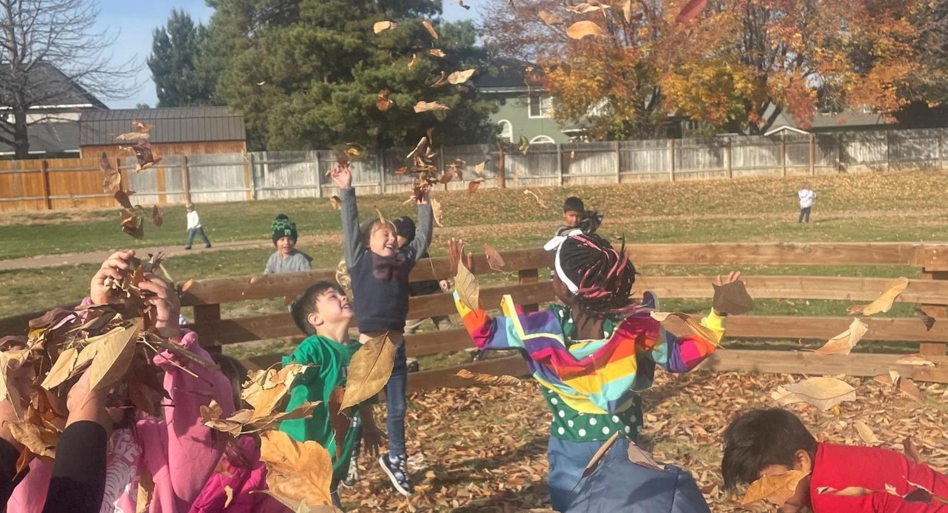 Students throwing leaves