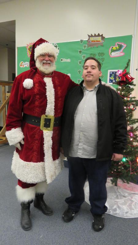 Santa poses with student organizer David Gomez.