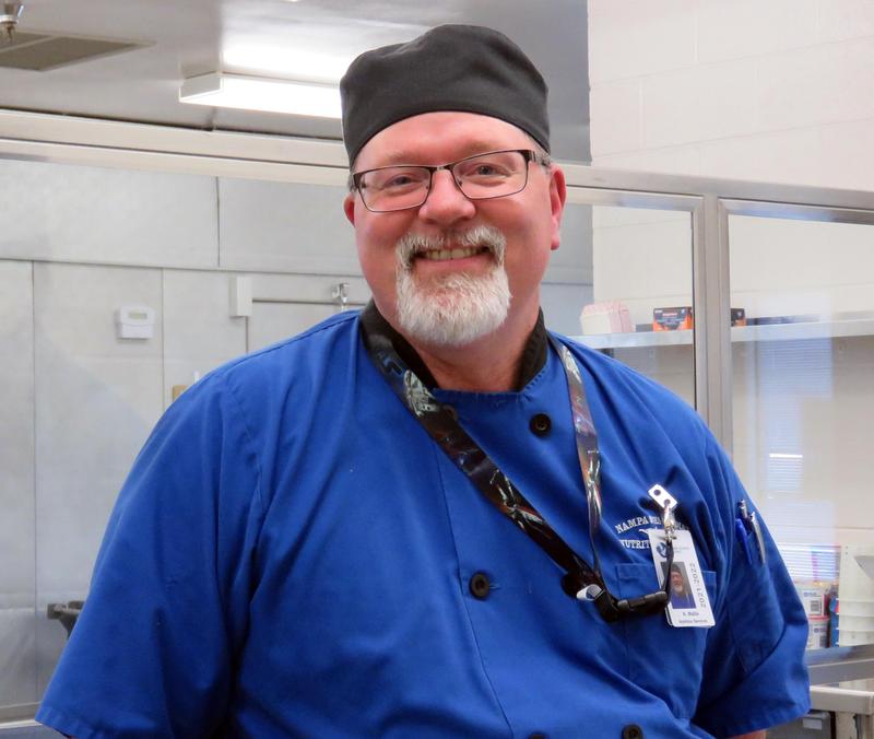 Kurt wears a blue NSD uniform and a black wrap hat.