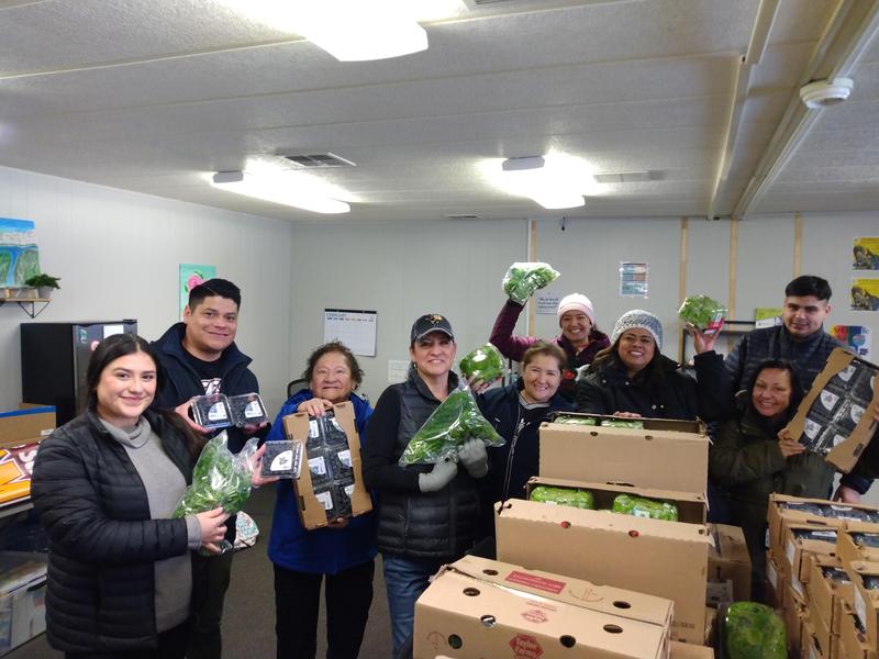 Staff at the Family and Community Resource Center happily show off a shipment of produce.