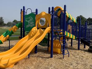 Green and yellow slide and climbing equipment at Sherman Elementary School.