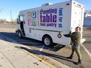 A student points to the Traveling Table delivery truck.
