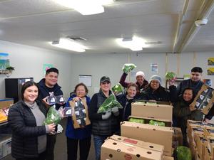 Staff at the Family and Community Resource Center happily show off a shipment of produce.