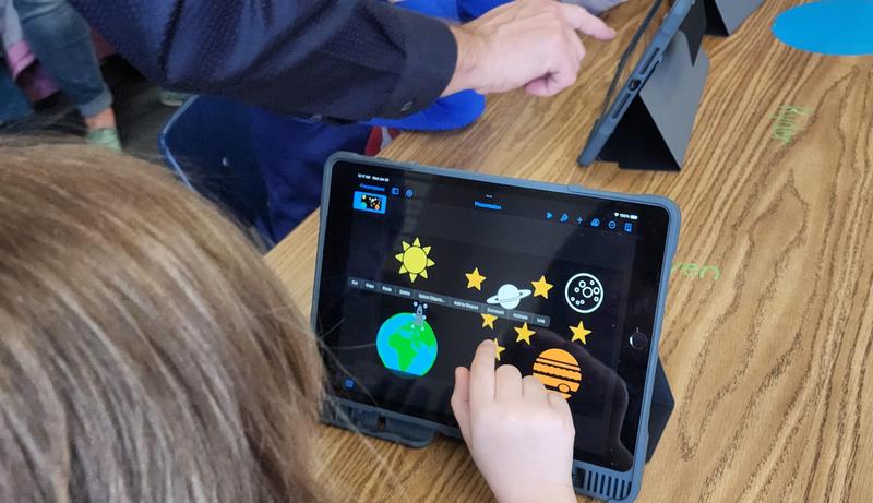 Girl clicks on image on her iPad.