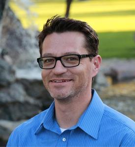Headshot of Gregg Russell in blue shirt