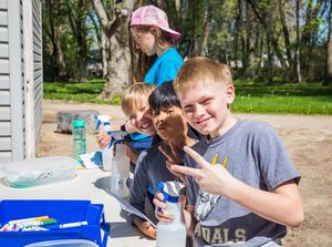 Students make \"v\" sign while working on a water project at Wilson Creek.
