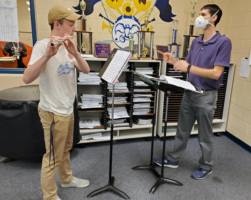 Student Trey Beldsoe practices his flute with help from band director Cody Peterman.