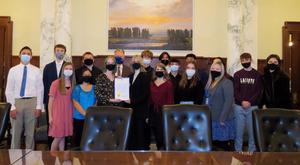 Students pose with the governor and his \"Next Steps Idaho\" proclamation at the governor\'s office.