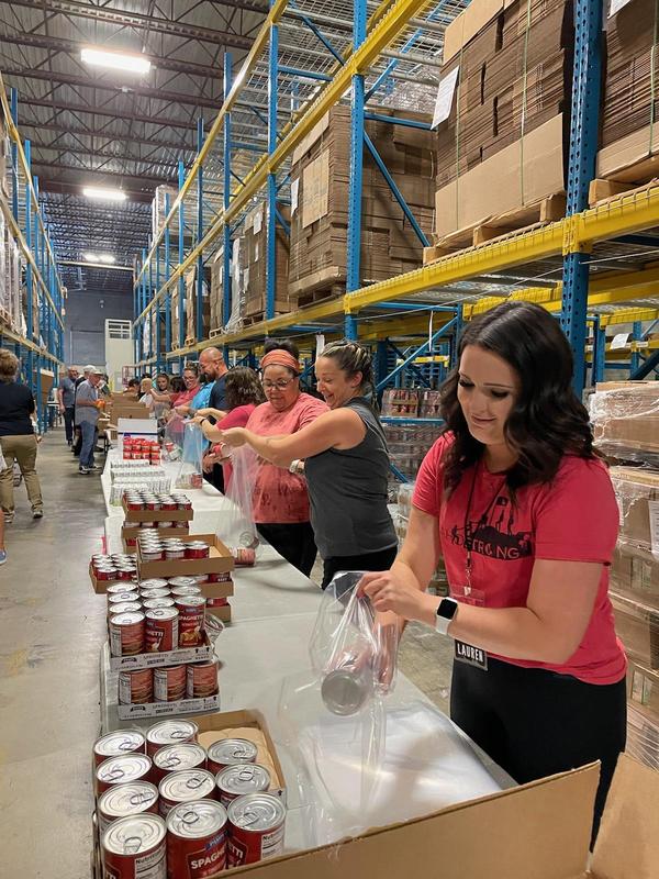 Volunteers package food for the Backpack Program at the Foodbank.