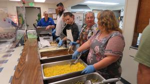 Volunteers wait to fill food orders.