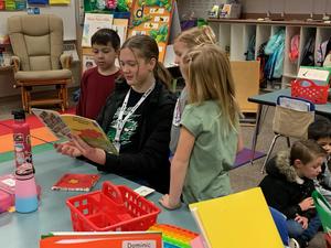 Lone Star student reading to kindergarteners
