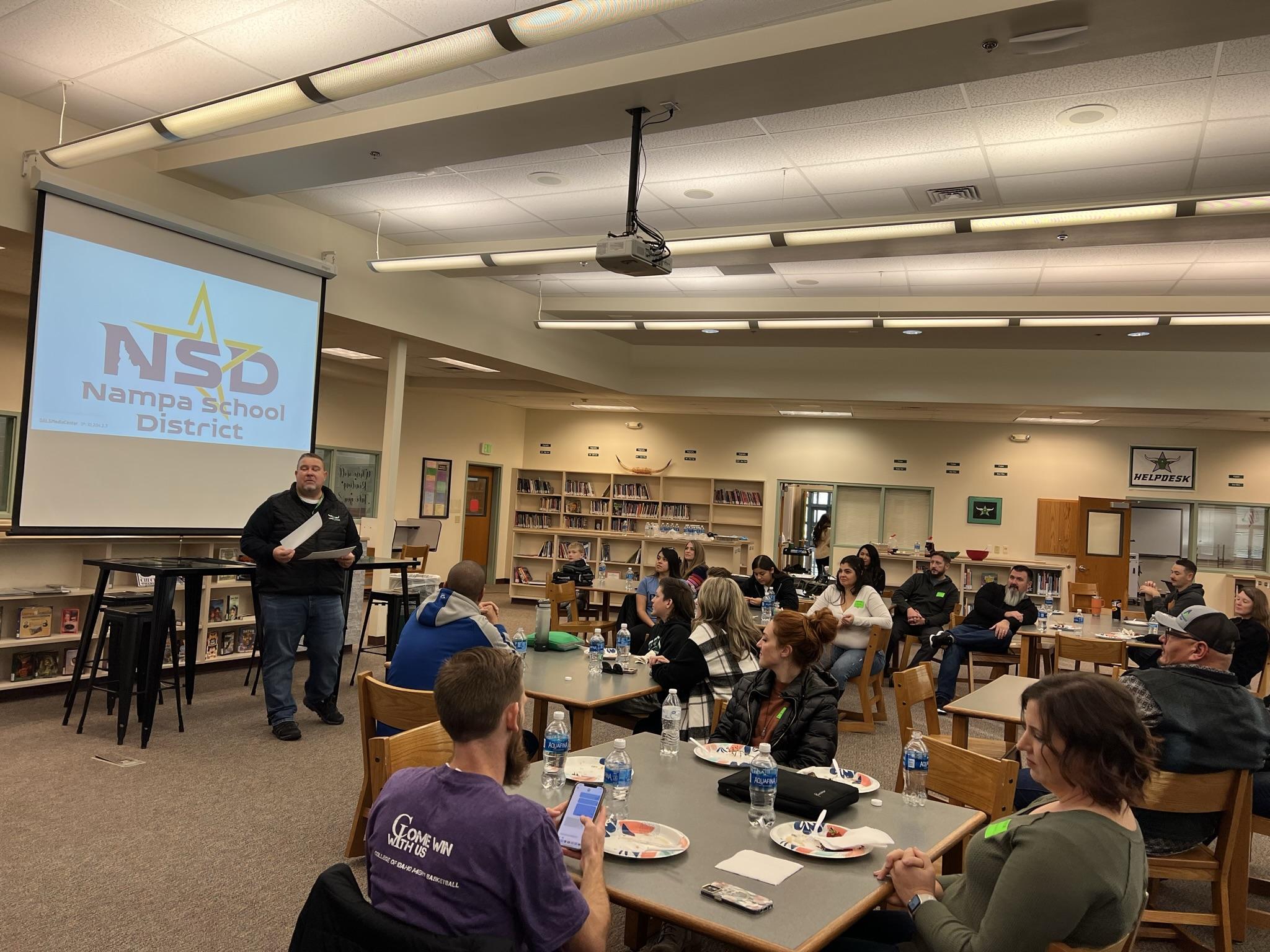 Principal Heideman speaks to a group of parents and students