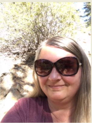 Headshot of Tracyee Becker wearing big sunglasses.