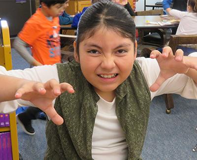 A girl roars for the camera.