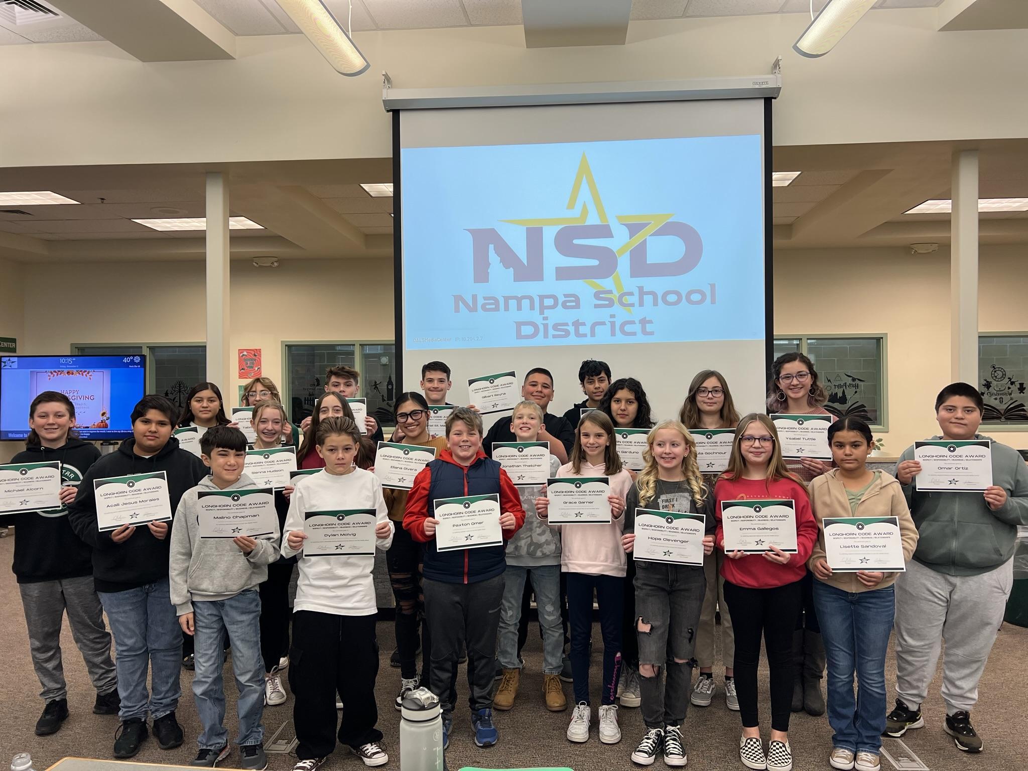 Students holding up certificates