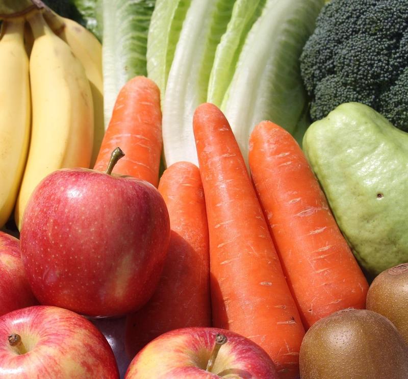 Close up of fruits and veggies - bananas, apples, carrots, lettuce