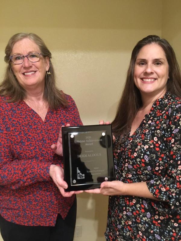 Heidi Aldous receives her plaque from an association member.