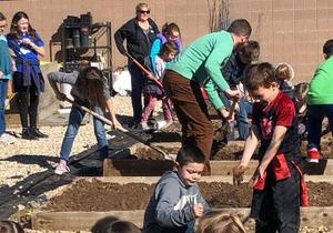 Children work to prepare the garden beds.