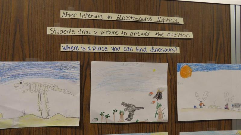Student drawings at Centennial Elementary show dinosaurs.