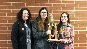 Sydney Tomaskovich and Alexis Zavala with their trophy and advisor.