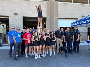 Nampa Cheerleaders pose with police officers outside the station.