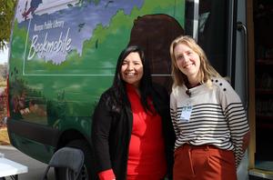 Two women smile outside the Nampa Bookmobile.