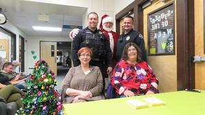 District staff and Nampa police officers greet guests at the front desk.