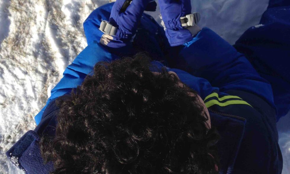 Top down view of a kid looking at their own teeth in a mirror